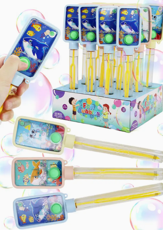 A hand holds a Capzone Marine Life Ring Toss Water Game Bubble Wand among colorful wands featuring whale, shark, and fish designs. The Fun Bubbles package is decorated with underwater illustrations.