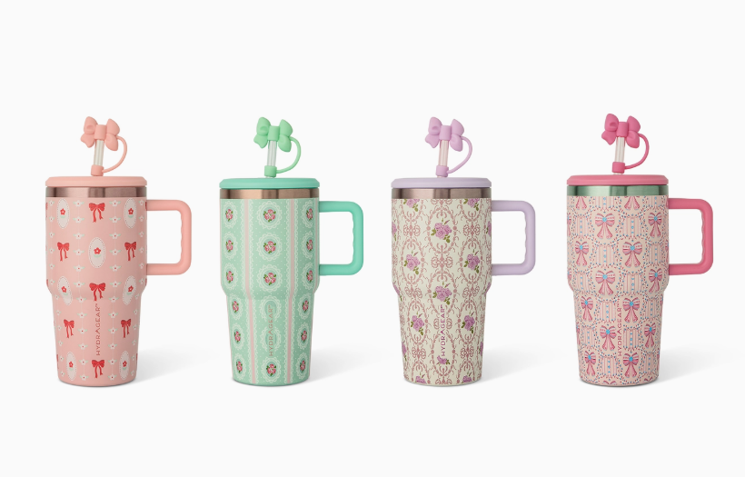 The core home Sweet Charm Tumbler set includes four pastel travel mugs, each with a unique pattern, bow-shaped straw, and differently colored handles—pink, mint green, lavender, and two hues of pink.