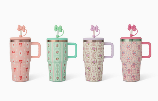 The core home Sweet Charm Tumbler set includes four pastel travel mugs, each with a unique pattern, bow-shaped straw, and differently colored handles—pink, mint green, lavender, and two hues of pink.