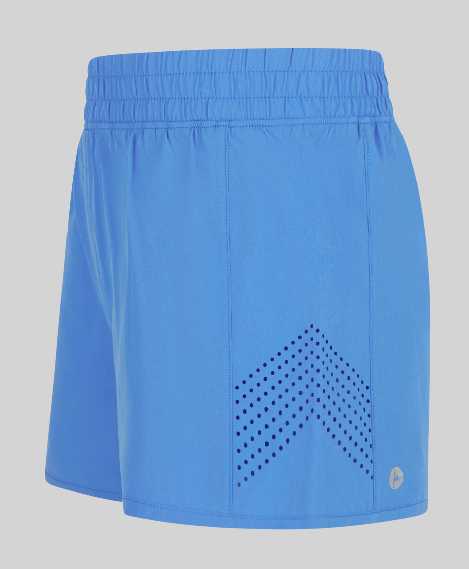 The Blue Light Running Short by 90 Degree by Reflex & Yogalicious features bright blue fabric, an elastic waistband, chevron-patterned black ventilation holes on one leg, and a subtle circular logo near the hem.