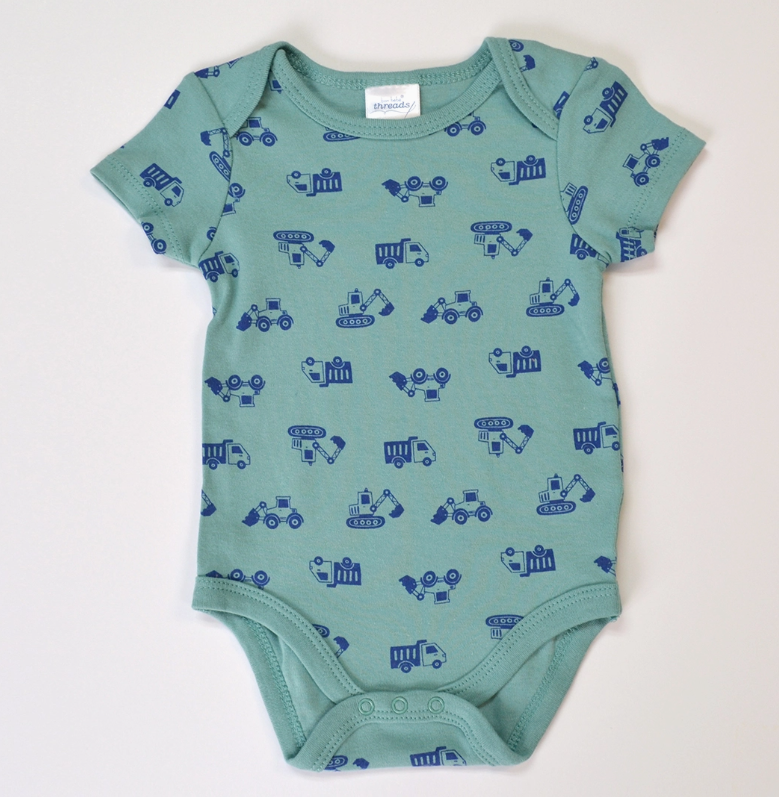 The Tiny Crew Bubble Trio by Lollipop Dreams is a light teal baby onesie featuring dark blue prints of trucks and tractors, set against a white background.