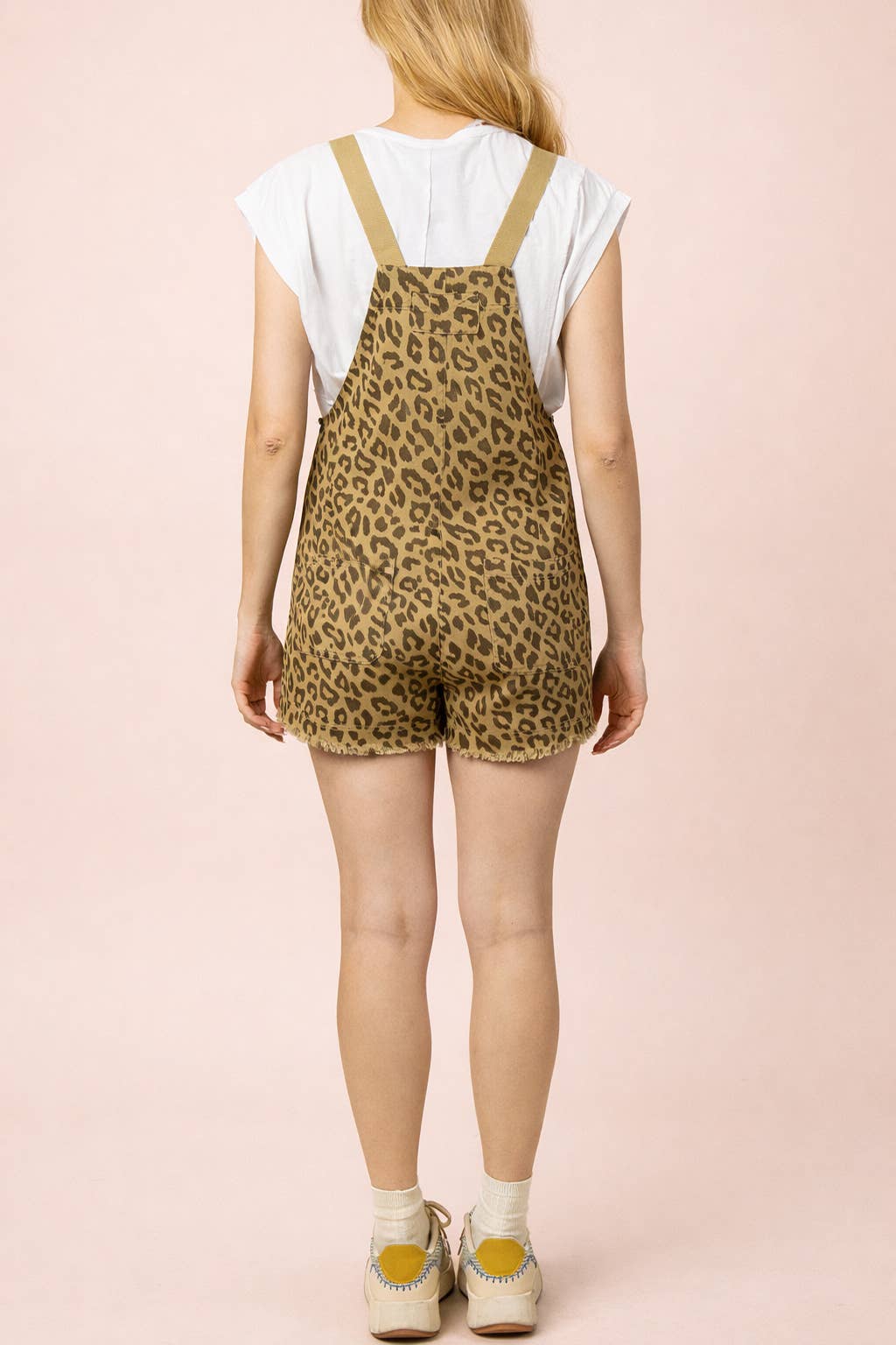 Back view of a person wearing a white t-shirt under olive green Leopard Print Casual Romper shorts with a frayed hem.