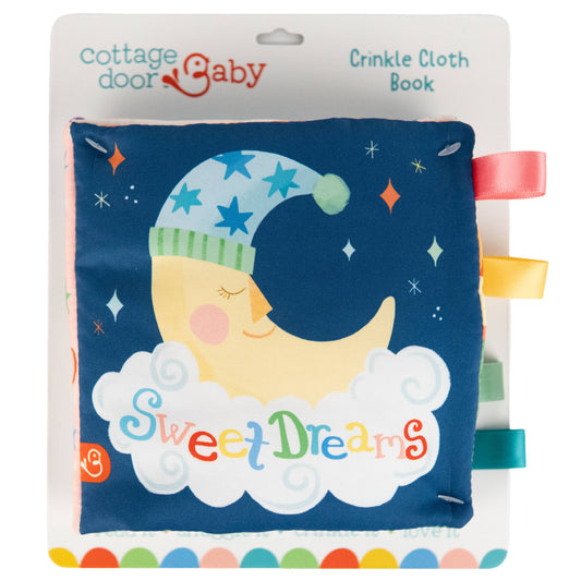 The Sweet Dreams Cloth Book by Cottage Door Press features a sleeping moon in a nightcap surrounded by stars and colorful ribbon tags along the side. With a soothing blue sky background and fluffy clouds, this charming sensory cloth book is perfect for bedtime routines with baby.