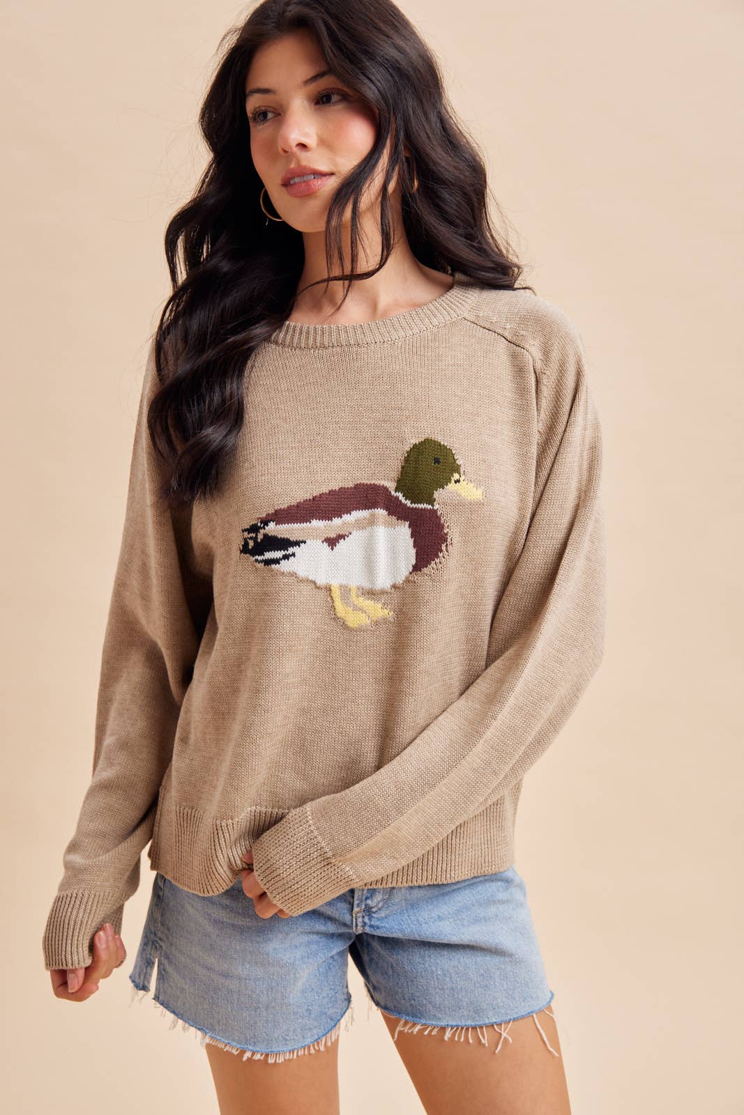 In Loom Mallard Duck Knitted Sweater, a tan long-sleeved crewneck with a knitted mallard duck design on the chest.
