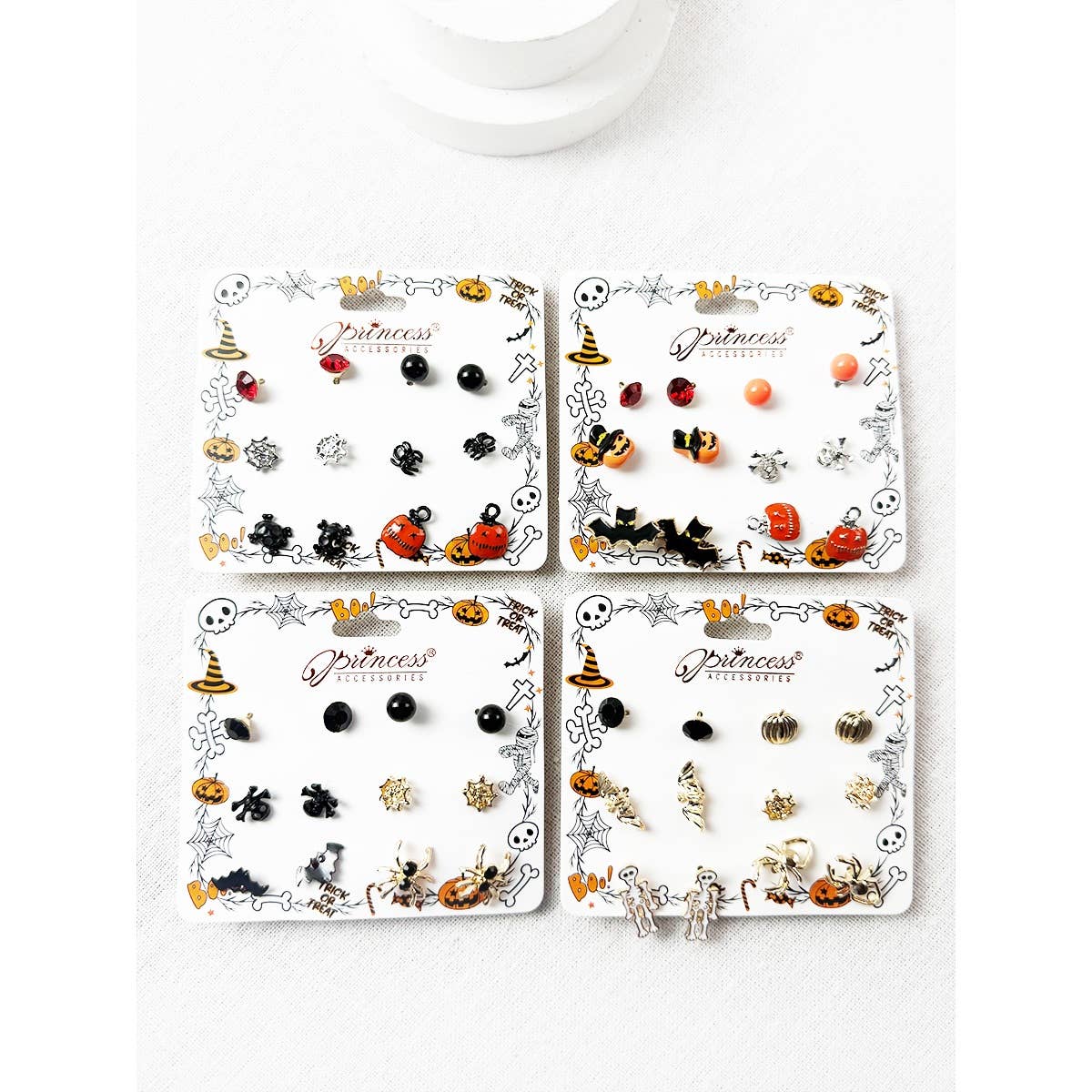 Cute Halloween Theme Earring Set featuring four pairs of stud earrings including jack-o-lanterns, ghosts, bats, spiders, and skulls, displayed on white backing cards.