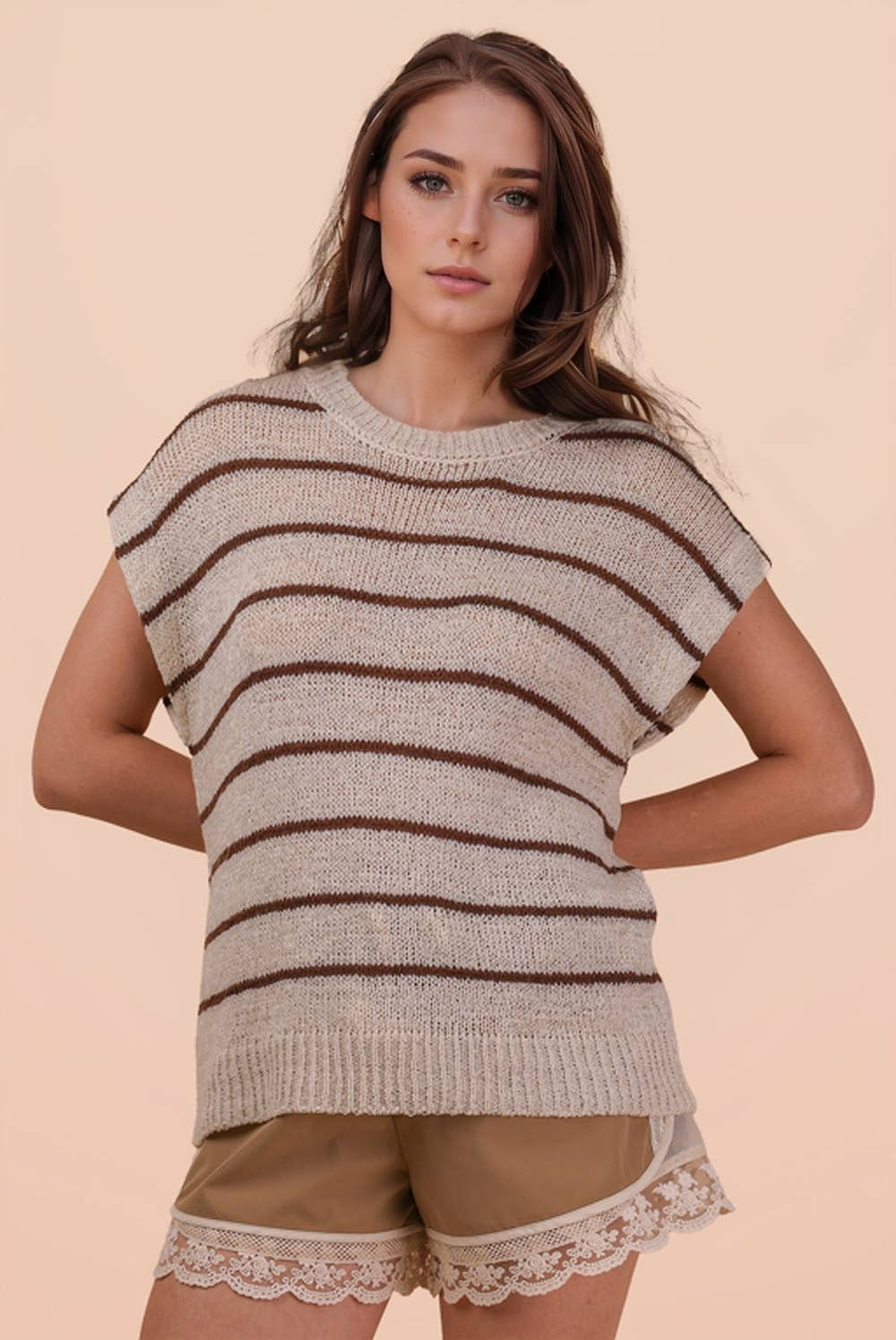 A person wearing a VERY J Striped Knit Sweater Vest Top with horizontal brown stripes and brown shorts with lace trim.