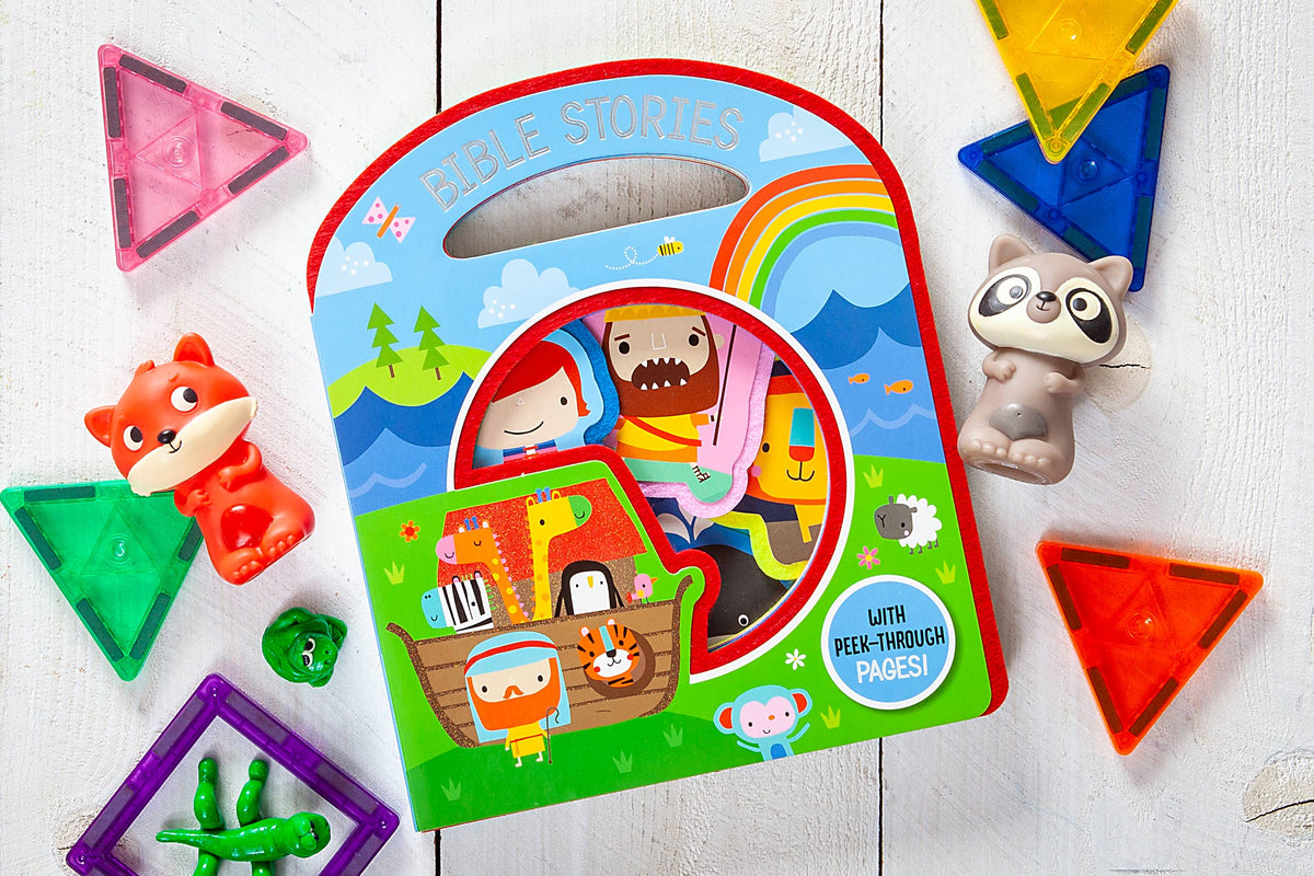 Busy Windows Bible Stories Felt Book by BroadStreet Publishing Group, LLC, featuring colorful illustrations of Noah’s Ark, displayed alongside animal toys and translucent magnetic shapes on a white wooden surface.