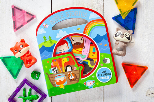 Busy Windows Bible Stories Felt Book by BroadStreet Publishing Group, LLC, featuring colorful illustrations of Noah’s Ark, displayed alongside animal toys and translucent magnetic shapes on a white wooden surface.