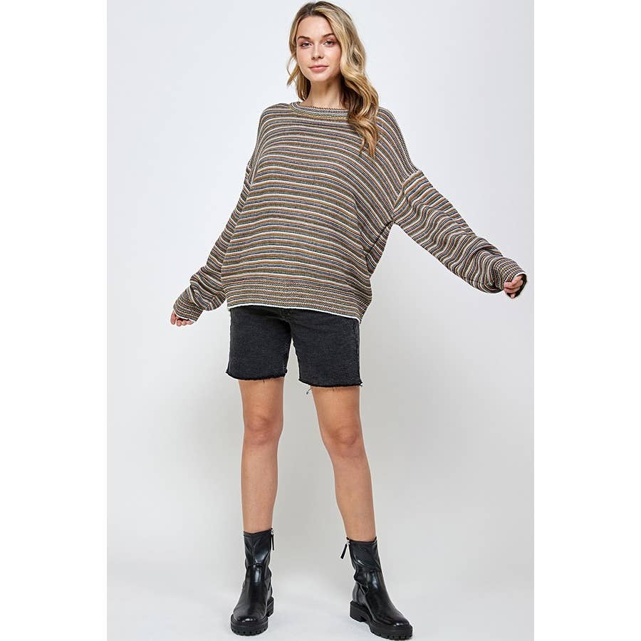 A person wearing a Sweet Generis Multi Color Stripe Pullover Sweater, black denim shorts, and black ankle boots.