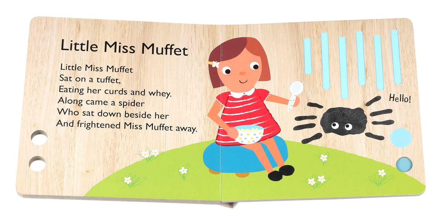 A children’s book illustration from Simon & Schuster’s "This Little Piggy Book" shows a piglet on a grassy hill with a bowl and spoon as a friendly black spider approaches, with the nursery rhyme text printed on the left page.