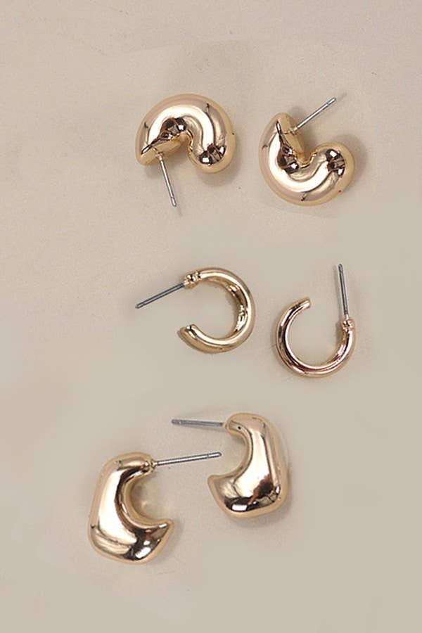 Bubble Hoop Trio Earrings by JOSSLYN by wall to wall, featuring three pairs of gold-toned hoop earrings in varying thicknesses arranged in a column.