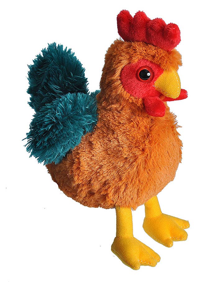 The Wild Republic Mini Rooster Stuffed Animal features orange-brown fur, a red comb and wattle, yellow beak and feet, and fluffy teal tail feathers, shown standing upright against a white background.