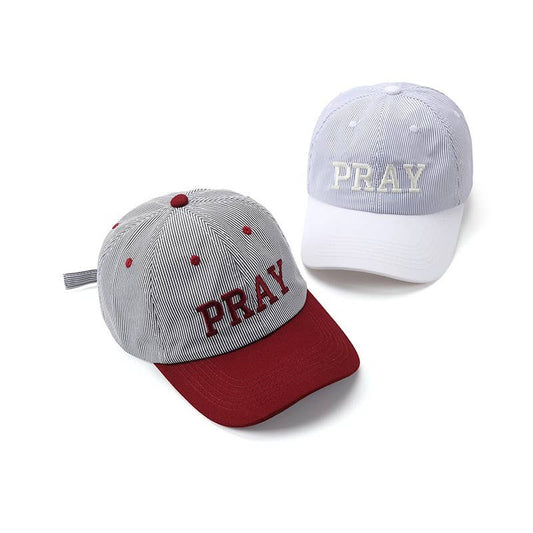 Two PRAY Striped Embroidered Hat caps in pinstripe, one with a maroon brim and one with a white brim, both featuring the word PRAY embroidered on the front.
