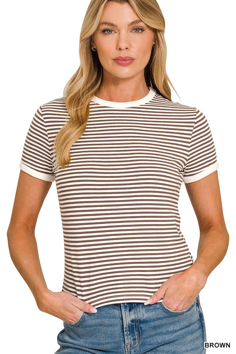 A woman stands facing forward with her hands in her pockets, wearing the 42POPS Striped Contrast Trim Tee—a brown and white short-sleeve t-shirt featuring a white collar and cuffs—paired with blue jeans.