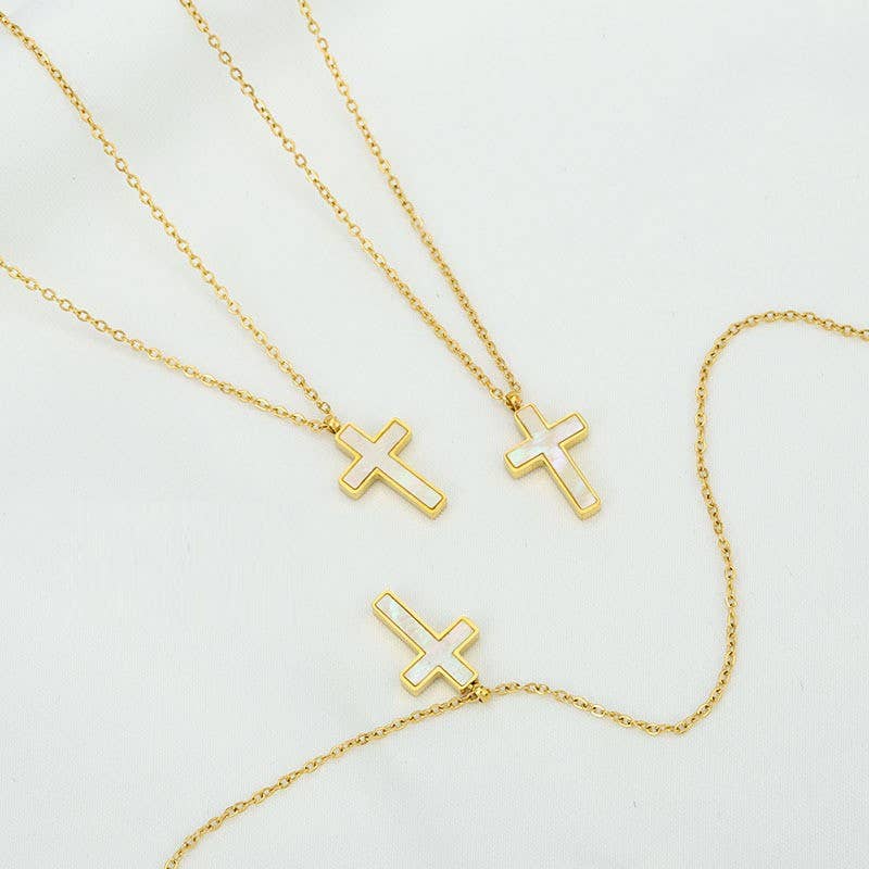 Three JOSSLYN by wall to wall Tarnish Free Cross Necklaces, each featuring a gold cross pendant, are arranged on a white background. Two crosses are upright, while one is placed horizontally at the bottom.