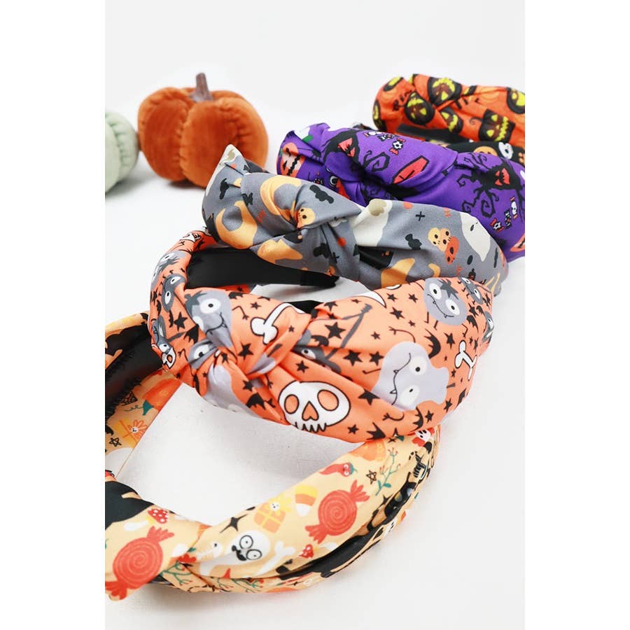 Four Love and Repeat Halloween Theme Headbands with knot details and various patterns featuring skulls, ghosts, pumpkins, and candy.