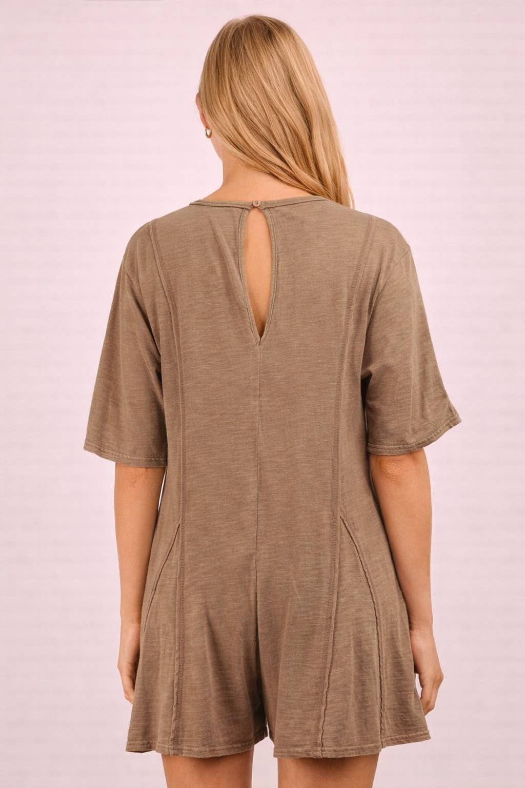 Back view of a VERY J Mineral Washed Oversized Romper in a neutral tone, featuring exposed seams and a keyhole cutout at the neckline.