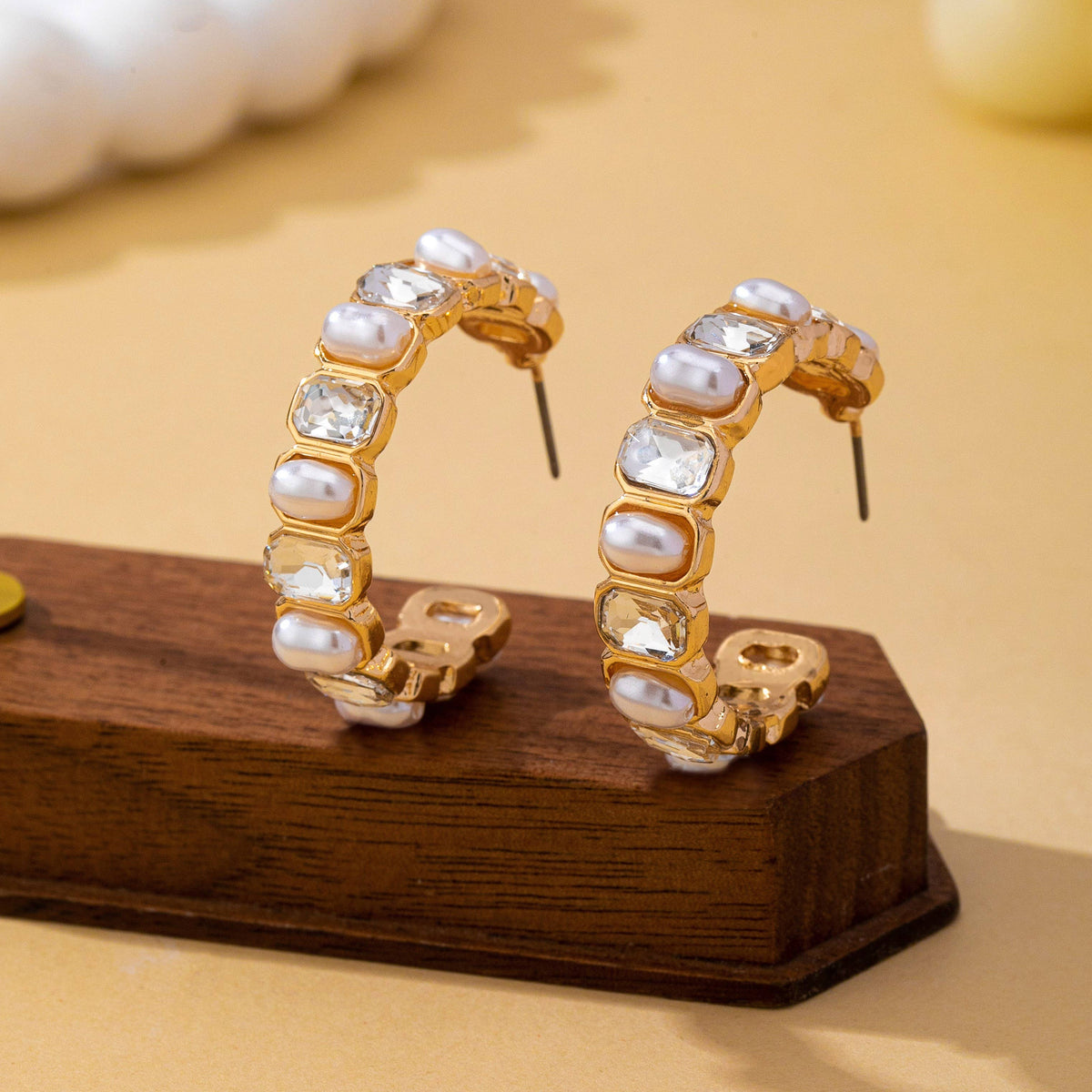 JOSSLYN by wall to wall Pearl & Rhinestone Hoop Earrings in gold featuring alternating white pearls and clear rectangular crystals.