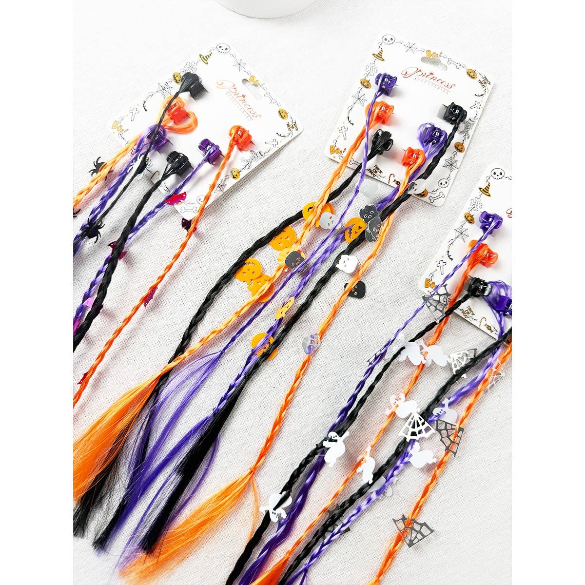 Two sets of Love and Repeat Halloween Braid Hair Extension Clips featuring colorful braids with small plastic pumpkins, ghosts, spiders, and spiderwebs.